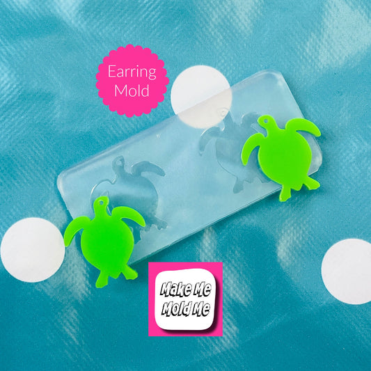 Earring mold with green turtle shapes on a blue background